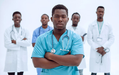 Wall Mural - smiling surgeon standing in front of his colleagues