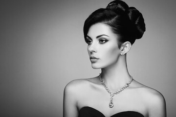 Wall Mural - fashion portrait of young beautiful woman with jewelry and elegant hairstyle. brunette girl. perfect