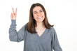 © OceanProd - pretty woman showing v two fingers positive and peace gesture hand on white background