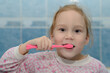 © alexnikit - shaggy girl in pajamas brushing his teeth
