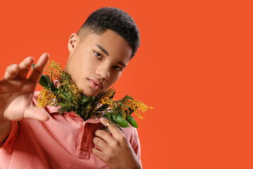 Poster - Creative portrait of handsome young man with flowers on color background