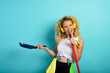 © alphaspirit - Funny housewife use broom like a rock microphone. cyan background