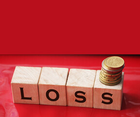 Wooden cubes with LOSS word on wooden table. Financial loss busines concept. Memory loss demetia mental health concept.