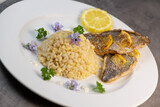 Fototapeta Mapy - Lemon-spiked sea bream fillet, cooked wheat risotto on plate