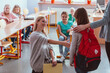 © Photographee.eu - Girl with a red backpack says hello to her friends on her first day of school