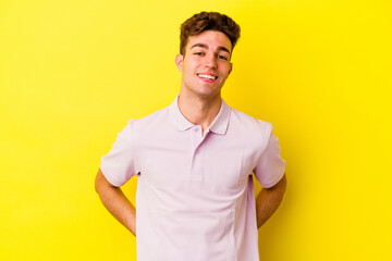 Wall Mural - Young caucasian man isolated on yellow background happy, smiling and cheerful.