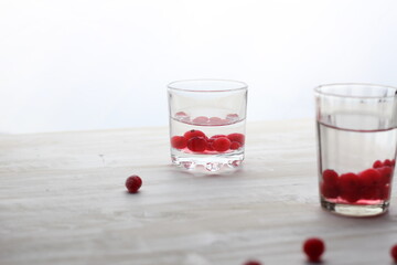 Wall Mural - Short glass with vodka and cranberries on white background