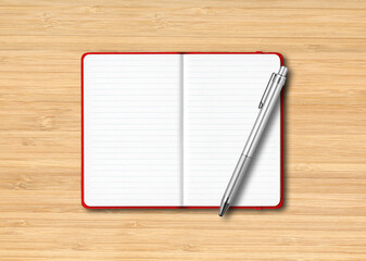 Poster - Red open lined notebook with a pen isolated on wooden background