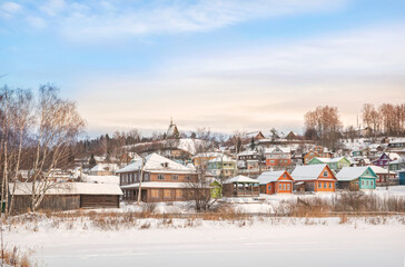 Wall Mural - Wooden houses on the banks of the snow-covered Shokhonka River in Plyos