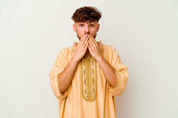 Wall Mural - Young Moroccan man isolated on white background shocked, covering mouth with hands, anxious to discover something new.