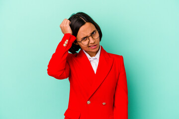 Young mixed race woman isolated on blue background celebrating a victory, passion and enthusiasm, happy expression.