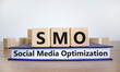 © Dzmitry - SMO, social media optimization symbol. Wooden cubes on book with word 'SMO - social media optimization' on beautiful white background, copy space. Business, SMO - social media optimization concept.