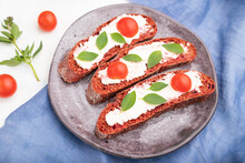 Red Beet Bread Sandwiches With Cream Cheese And Tomatoes On White Concrete Background. Side View, Selective Focus.