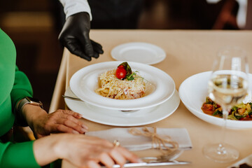 Serving of carbonara pasta with bacon, cheese and cream in restaurant.