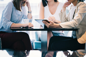 Business women discussing in a meeting. Technology, teamwork concept