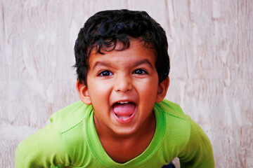 three year old indian baby boy in green t shirt