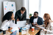 © Kateryna - Concentrated multiracial colleagues working together on project, discussing work questions. Stylish business people at the conference, sitting in office, learning financial graphs