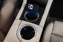 Mobile Phone At The Cup Holder Of Modern Supercar