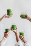 Fototapeta Kuchnia - Glasses of detox healthy green smoothie in hands