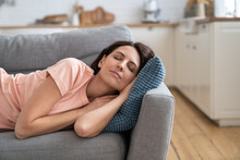 Young Mom Lying On On Pillow On Couch, Resting, Sleeping After Completing House Working. Woman Napping On Sofa In Living Room, Feel Fatigue, Relaxing. Leisure, Lazy Time Concept.