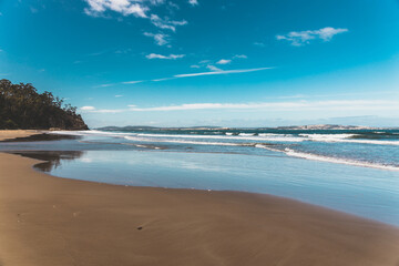  Kingston beach in southern Hobart in Tasmania, Australia on a sunny windy day with intense swell and waves and no people