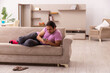© Elnur - Young man watching tv at home during pandemic