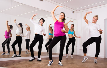 women dancing aerobics at lesson in the dance class. high quality photo