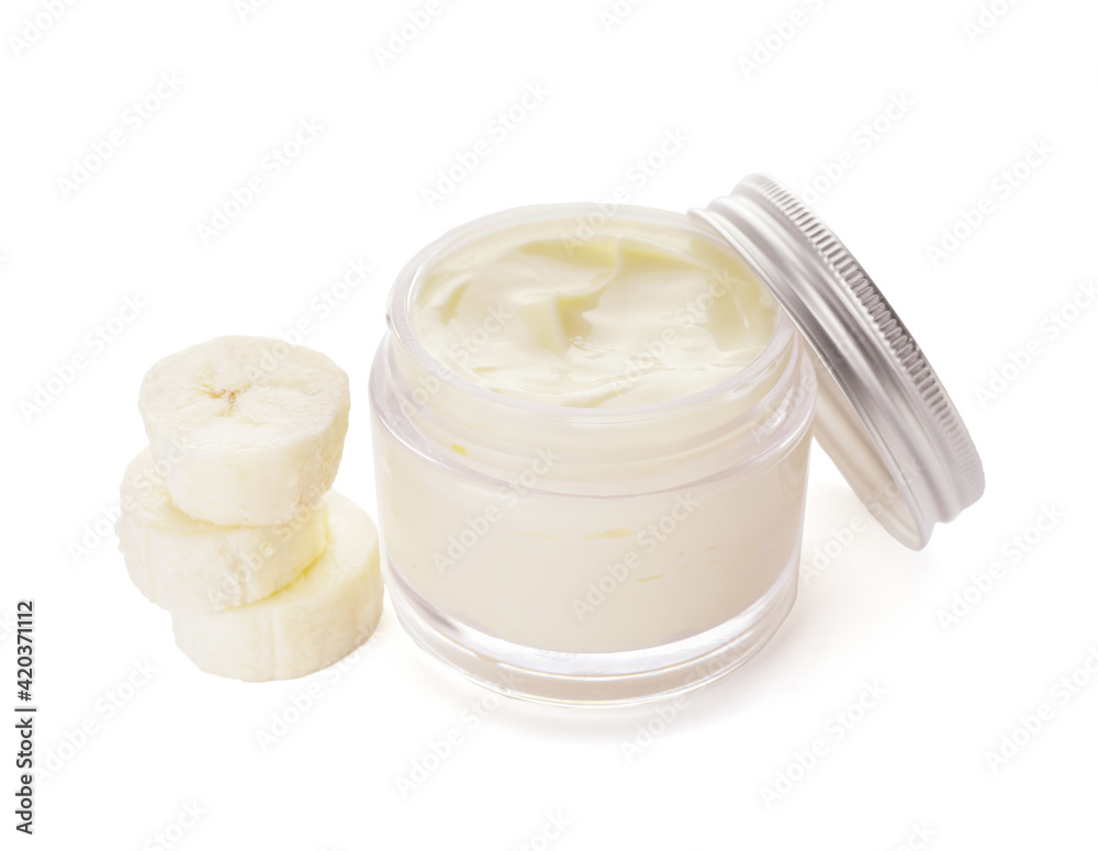 Jar of natural banana cream on white background