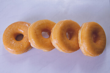 Wall Mural - delicious sugary donuts on marbled white background