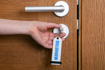 Canvas Print - Marketing Concept. Unlocks the wooden door with a key