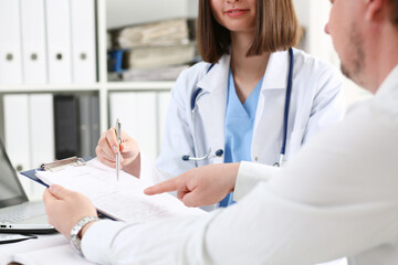 Wall Mural - Female doctor hand hold silver pen and showing pad