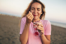 Girl Eating Ice Cream On The Beach