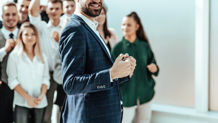 Wall Mural - happy business man standing in front of his team.