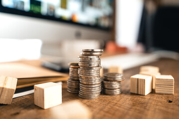 Wall Mural - Money coin Grow up business and computer Concept,Silver coins stacked on wooden desks.