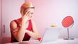 © CameraCraft - Online dating. Young woman in red dress having online date on Valentines day. Shy smile. High quality photo