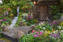 Landscaped Backyard Of Old House With Flower Garden