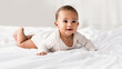 © Prostock-studio - Cute little African American baby lying on bed at home
