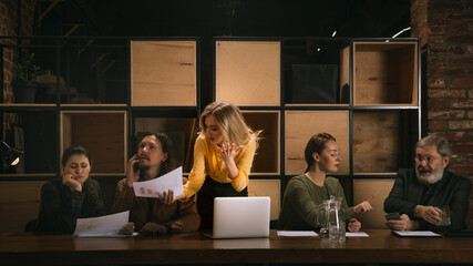 Wall Mural - Graphs. Young colleagues working together in a office styled like classical artworks. Look busy, attented, cheerful, successful. Medieval, renaissance mood. Concept of business, office, finance.