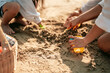 © Garun Studios - Happy parents and kid having fun with playing sand in summer vacation on the beach.Travel,Happy family and vacation concept.
