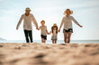 © Garun Studios - Happy asian family, Parents are holding hands their children and walking on the beach in holiday.Family, travel, beach, relax, lifestyle, holiday concept.