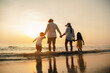 © Garun Studios - Happy asian family at consisting father, mother,son and daughter having fun playing beach in summer vacation on the beach.Happy family and vacations concept.