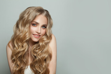 Wall Mural - young blonde woman smiling on white background