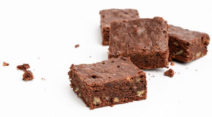 baked chocolate brownie pieces with walnut isolated on white background