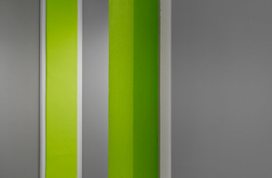 Abstract lines of bright green with grey and white walls