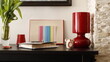 Komódka mebel w salonie z ramką czerwoną, karteczką kolorową i lampką szklaną bordową