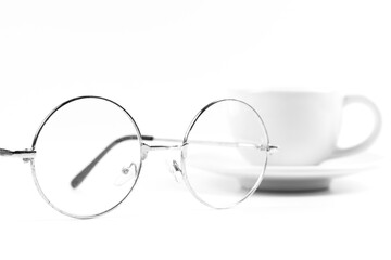 Round glasses with coffee mugs on white background and isolated.