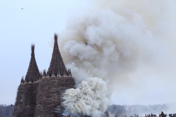 Wall Mural - Russian Maslenitsa. Celebration of Maslenitsa 2021. Traditional national holiday, folk game in Nikola-Lenivets, Kaluga region, Russia. Russian landmark. Burning wooden castle. Fire, performance, event