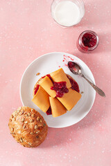 Wall Mural - fresh bun with Norwegian brunost traditional brown cheese and jam