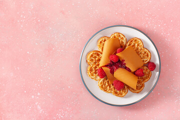 Wall Mural - waffles with Norwegian brunost traditional brown cheese and raspberry jam