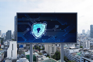 Padlock icon hologram on road billboard over panorama city view of Bangkok at day time to protect business, Southeast Asia. The concept of information security shields.